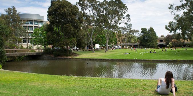 Students on Simpson Lawn overlooking the La Trobe moat