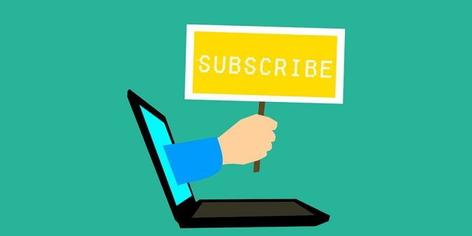 Hand coming out of computer holding sign saying subscribe