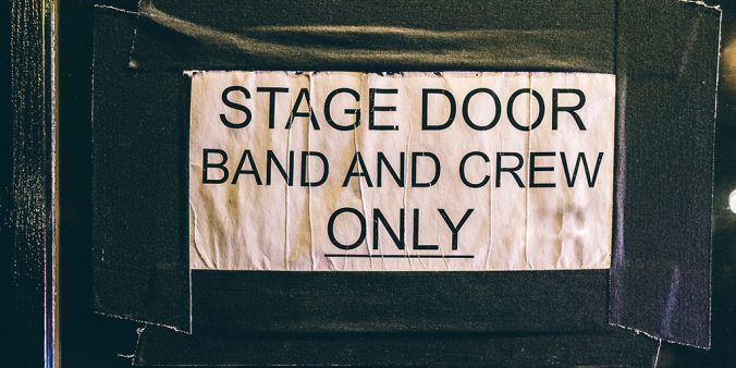 Door sign reading "Stage door band and crew only"