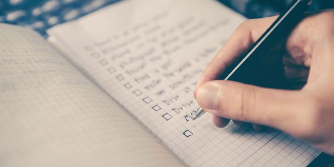 Hand checking off items on a list