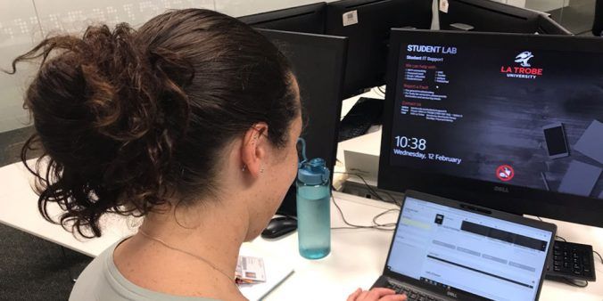 Female sitting editing web content on computer