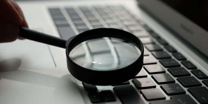 magnifying glass above laptop keyboard
