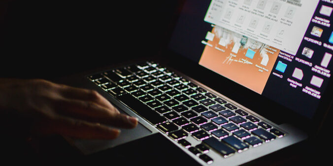 hands typing on computer keyboard