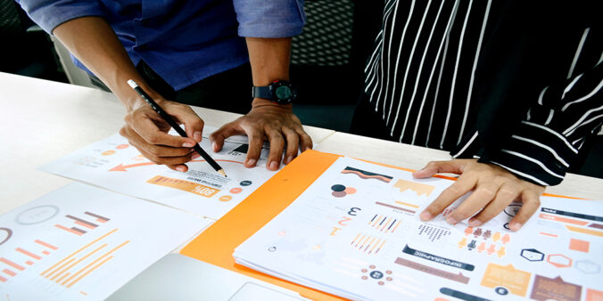 Two people analysing graphs