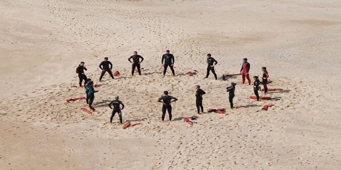A group of lifeguard circling on the beach